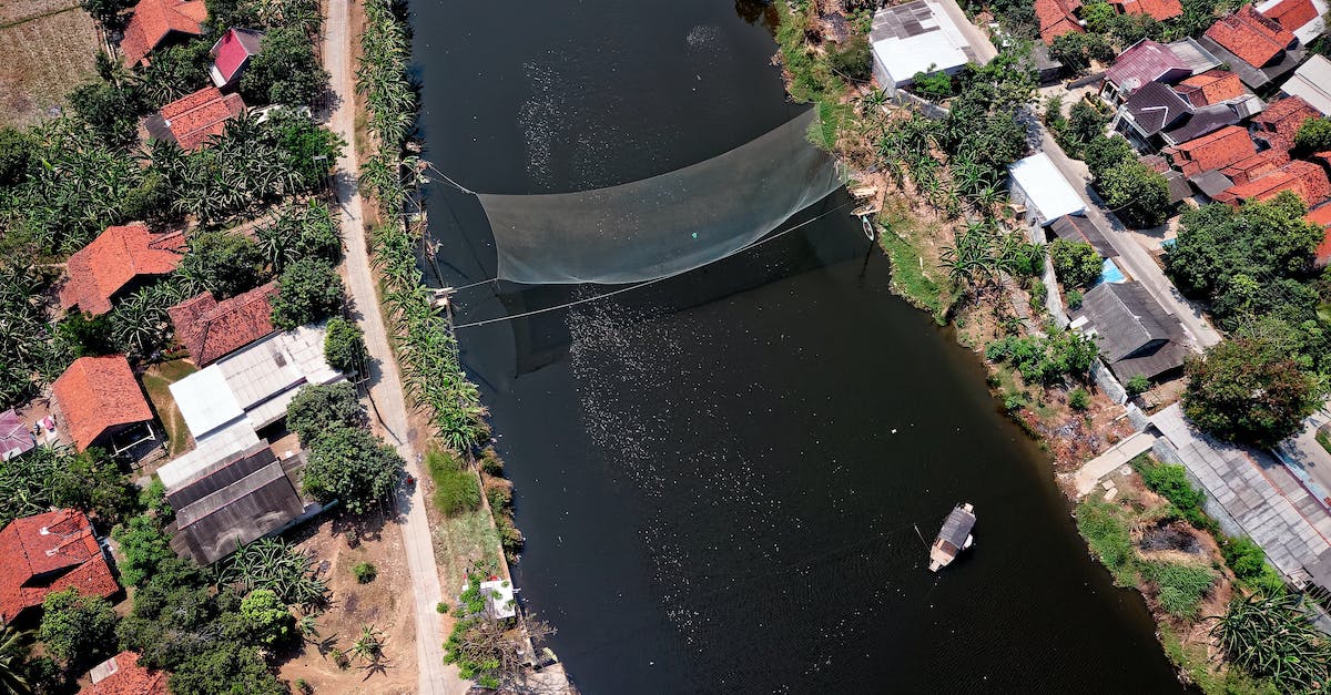 How is a hero's Net Worth calculated? - Bird's Eye View Photography of River in Between Houses