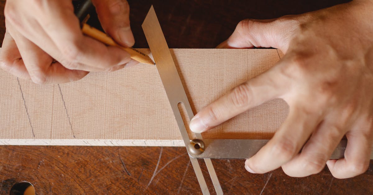 How is diagonal block distance measured in minecraft? - Top view of crop anonymous woodworker drawing diagonal line on wooden block using bevel on workbench