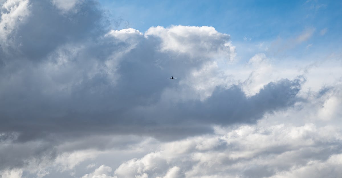 How is engine thrust calculated in environments with atmospheres greater than 1 atm? - Plane flying over clouds in blue sky