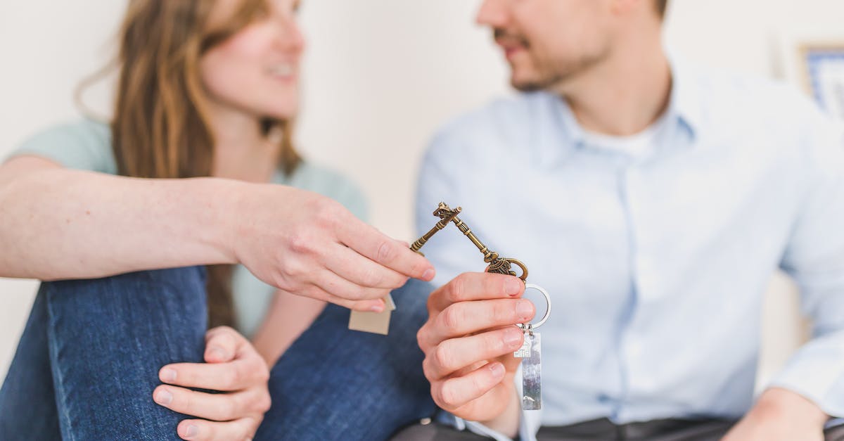 How is portal ownership decided? - Man and Woman Sitting while Holding Keys