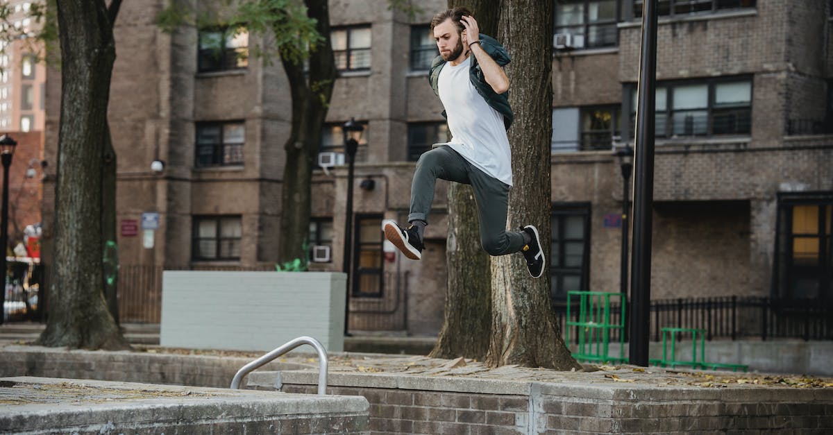 How is rank determined in Valkyria Chronicles? - Side view of young bearded man in casual outfit doing parkour in city park How is rank determined in Valkyria Chronicles? - Side view of young bearded man in casual outfit doing parkour in city park