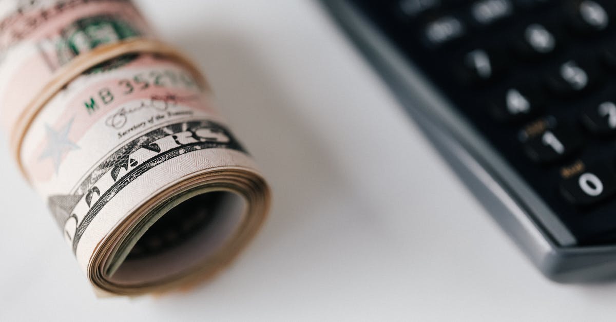 How is the Damage Roll Multiplier for Kinetic Knights Calculated in Pathfinder Kingmaker? - From above closeup of plastic calculator with number symbols on buttons near roll of American paper money tied with rubber band