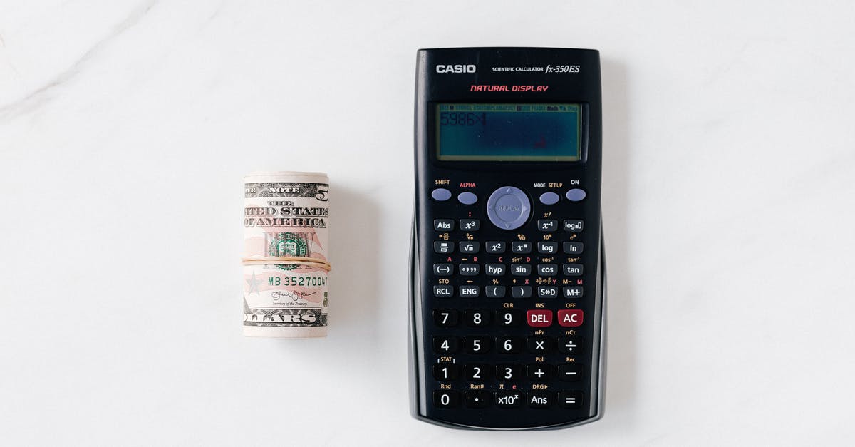 How is the Damage Roll Multiplier for Kinetic Knights Calculated in Pathfinder Kingmaker? - Top view of calculator with plastic multicolored buttons and display near roll of dollar banknotes tied with rubber band on white surface