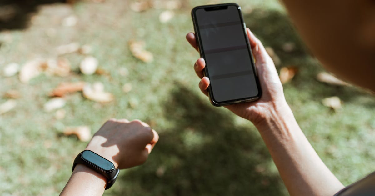 How is the park rating calculated? - Crop anonymous woman in smart watch surfing internet on smartphone