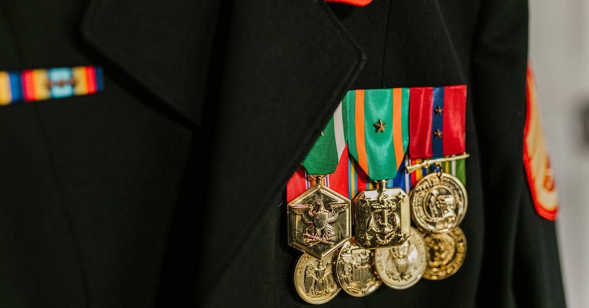 How is XP awarded for combat? - Close-Up Photo of Navy Uniform with Gold Medals