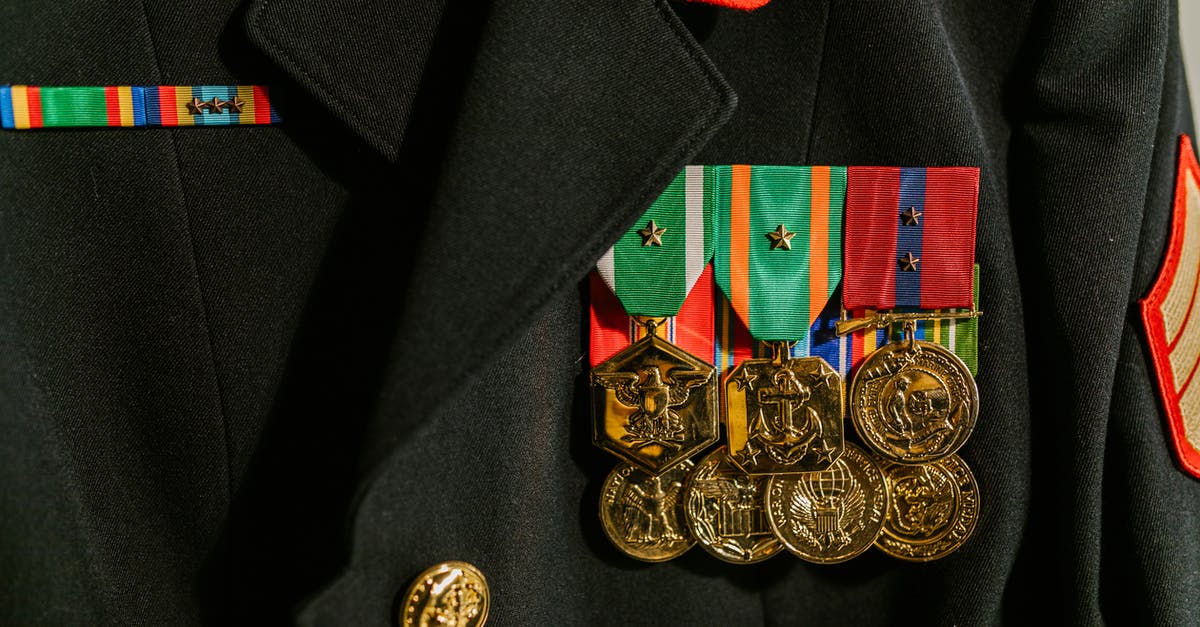 How is XP awarded for combat? - Close-Up Photo of Military Uniform with Medals