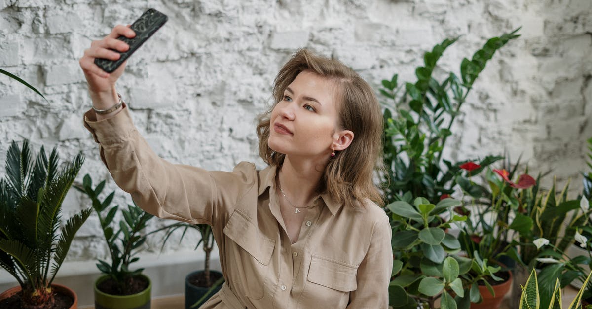 How long does it take plants to grow? - Photo of Woman Taking Selfie Using Smartphone Near Potted Plants