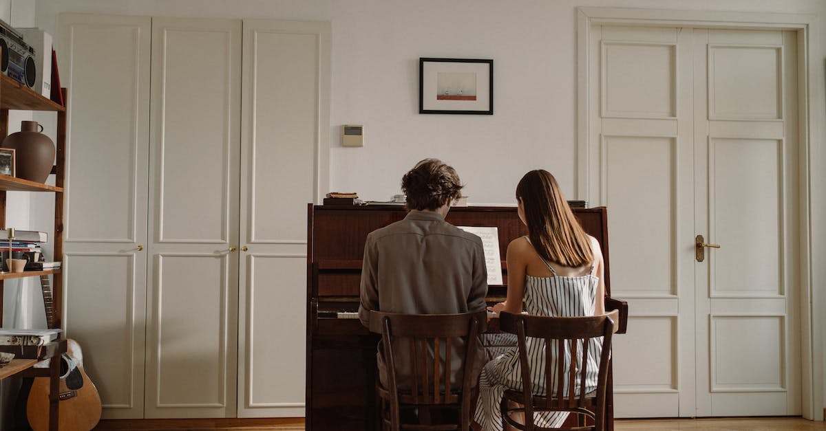 How long does it take to unlock another frame by playing one of the base frames? - Back View of a Couple Playing the Piano Together