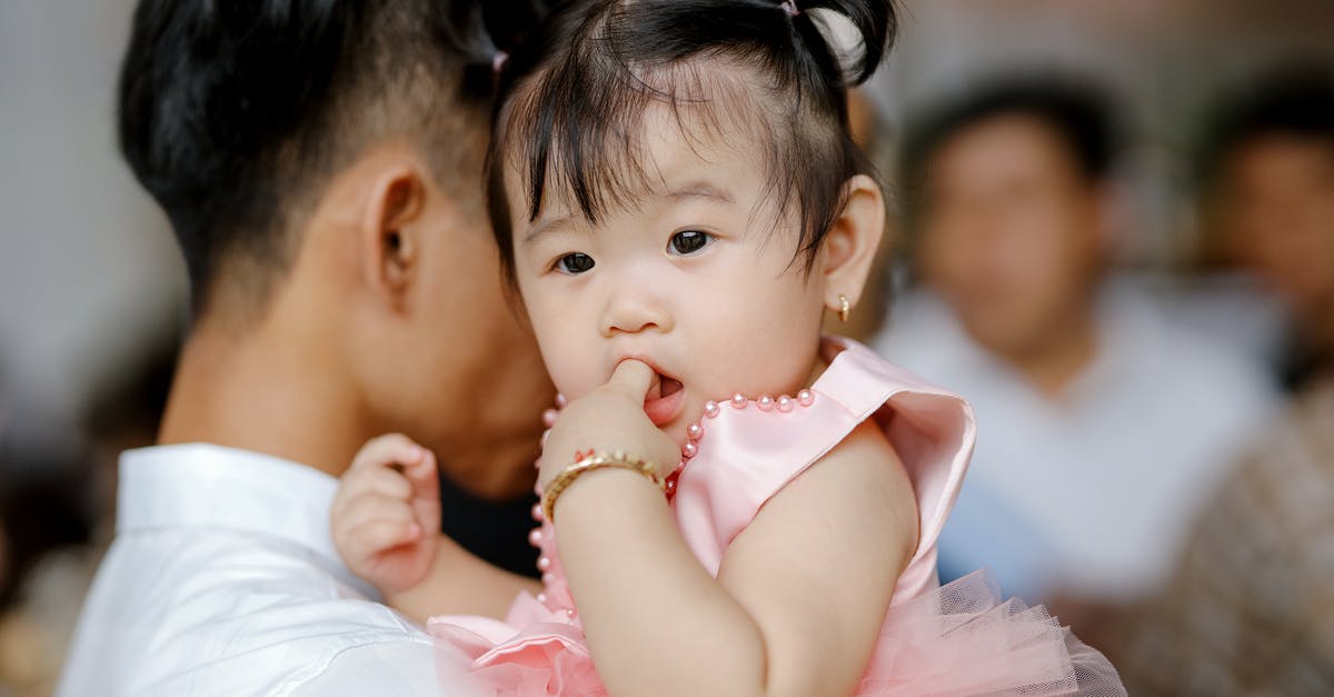 How long does life support last indoors? - Adorable Asian toddler with ponytails in pink dress sitting on hands and sucking finger How long does life support last indoors? - Adorable Asian toddler with ponytails in pink dress sitting on hands and sucking finger