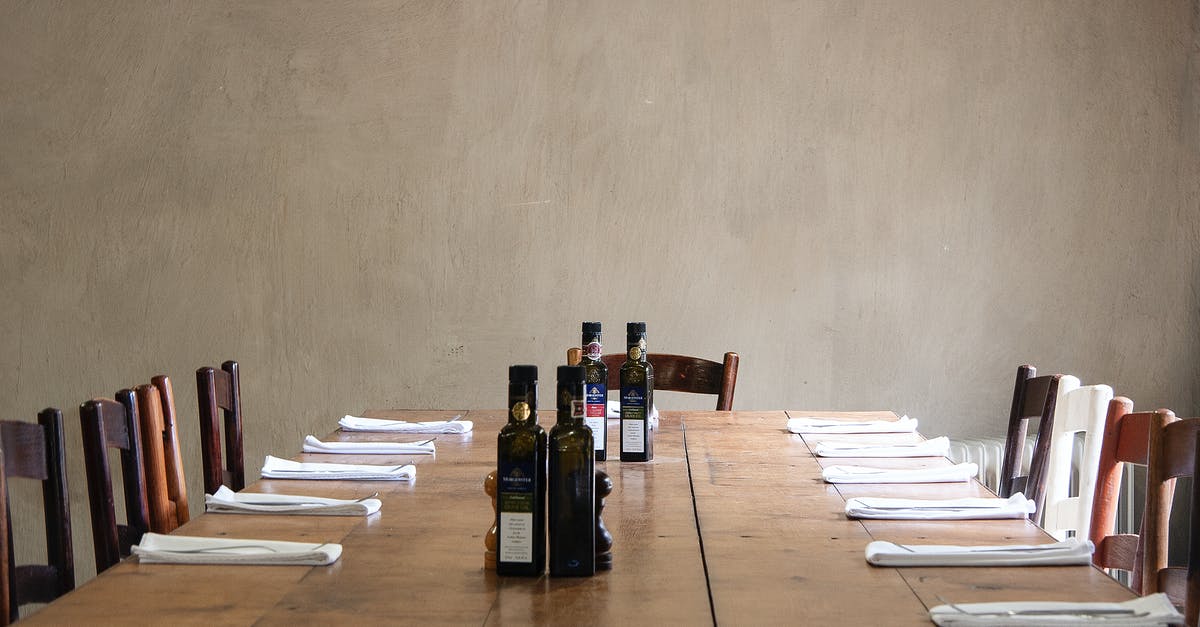 How long does oil last for the sword and shield? - Wooden table with bottles of olive oil and cutlery