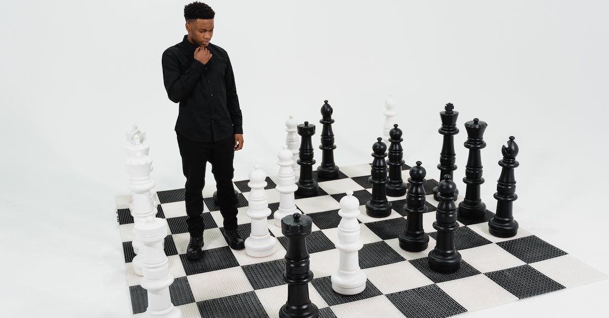 How long does the game last? - A Man in a Black Long Sleeved Shirt on a Big Chessboard