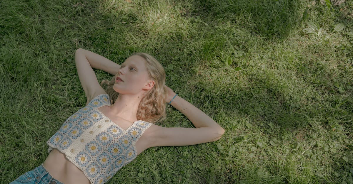 How long is a day in my village? - Blond Young Woman Laying on Lawn on Summer Sunny Day How long is a day in my village? - Blond Young Woman Laying on Lawn on Summer Sunny Day