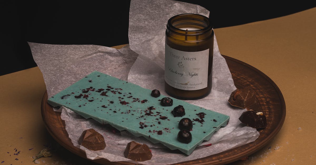 How many candies are in the jar? - Chocolates and Glass Jar with Candle on Brown Plate