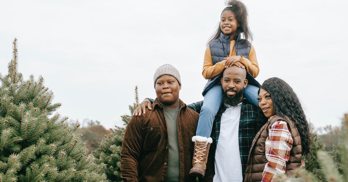 How many children can I adopt? - Cheerful black family choosing fir tree together