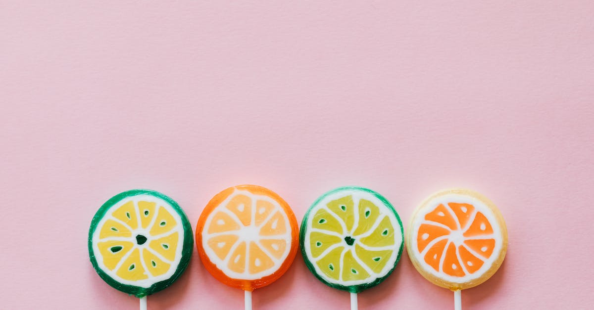 How many different combinations of player choices are there in Cinders? - Top view of round multicolored candies with citrus fruit flavor on thin plastic sticks on pale pink surface