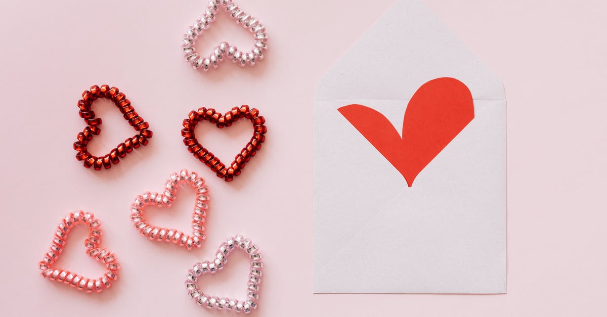 How many doomed units does each square take to corrupt? - Top view of different hearts made of multicolored bobbles near white envelope with handmade red heart on pink background