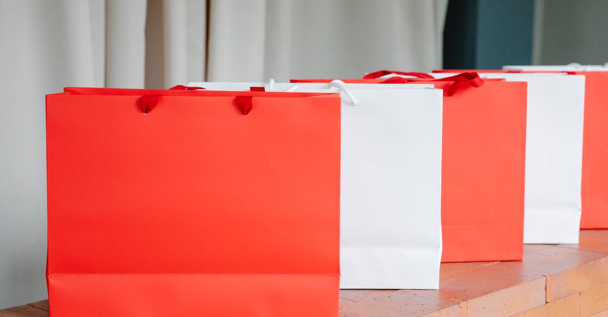 How many items can I REALLY hold in my bag in Pokemon Go? [duplicate] - Set of red and white paper shopping bags placed on brick shelf in studio