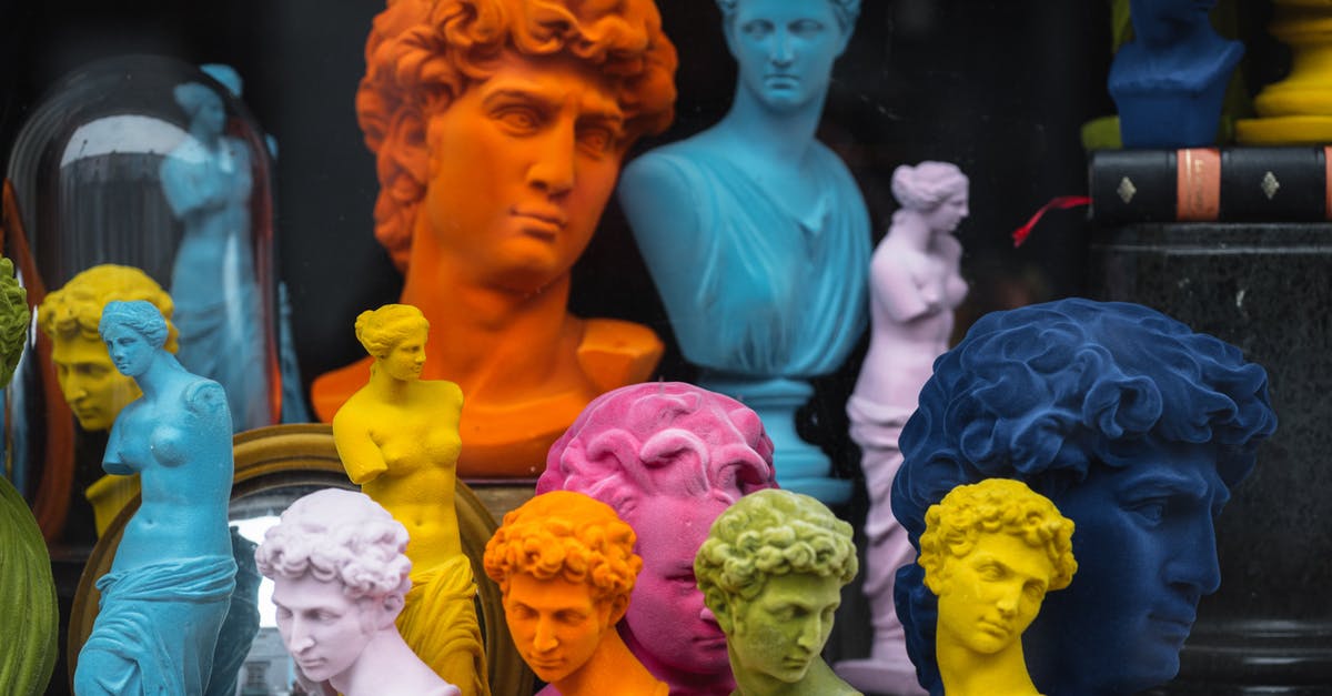 How Many Passengers? - Multicolored head sculptures of David near bright statuettes placed in store with abundance of souvenirs and black pillar with book How Many Passengers? - Multicolored head sculptures of David near bright statuettes placed in store with abundance of souvenirs and black pillar with book