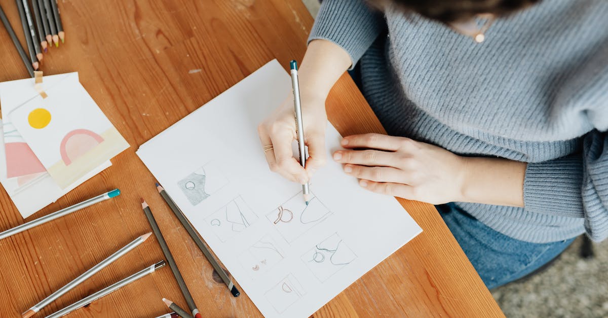 How many points do the skill upgrades cost? - Crop unrecognizable designer drawing with pencil on sheet of paper How many points do the skill upgrades cost? - Crop unrecognizable designer drawing with pencil on sheet of paper