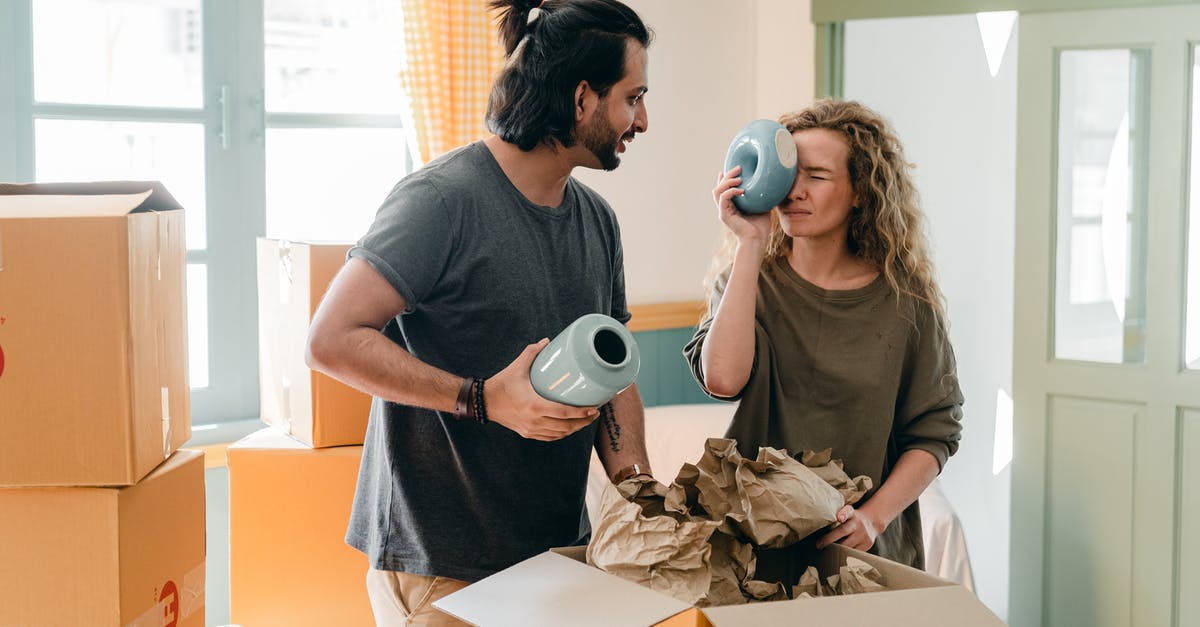 How many rooms can merge together? - Multiethnic couple with ceramic vases and pile of cardboard boxes How many rooms can merge together? - Multiethnic couple with ceramic vases and pile of cardboard boxes