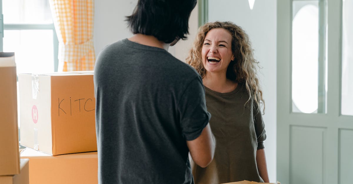 How many rooms can merge together? - Joyful woman interacting with boyfriend near pile of boxes How many rooms can merge together? - Joyful woman interacting with boyfriend near pile of boxes