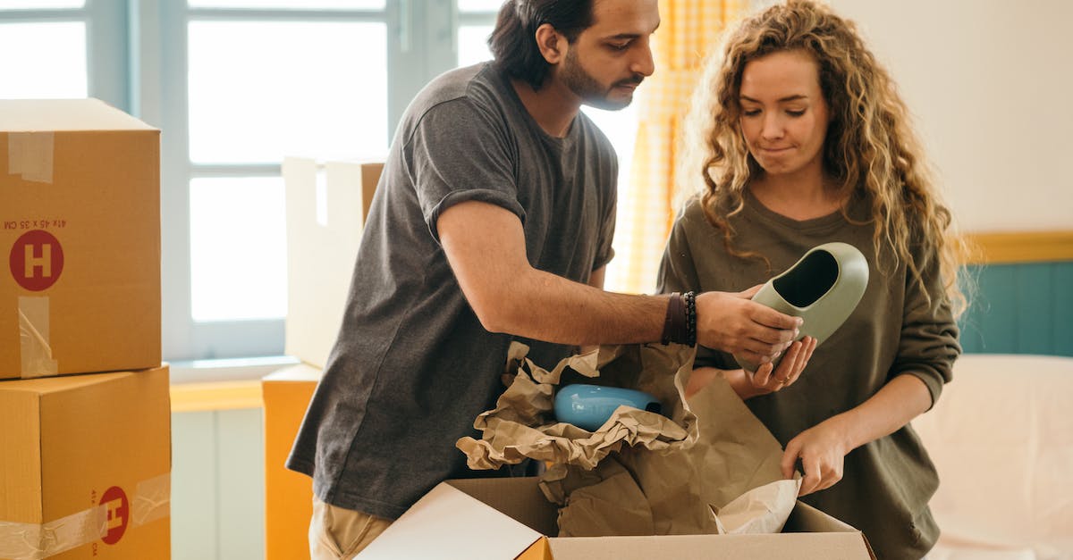 How many rooms can merge together? - Pensive multiracial couple unpacking vase after renting new apartment How many rooms can merge together? - Pensive multiracial couple unpacking vase after renting new apartment