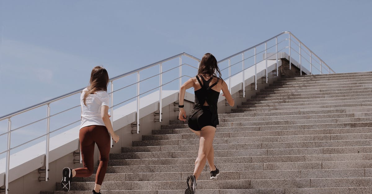 How many steps is one run around Prism Tower? - Women Running on Gray Concrete Stairs How many steps is one run around Prism Tower? - Women Running on Gray Concrete Stairs