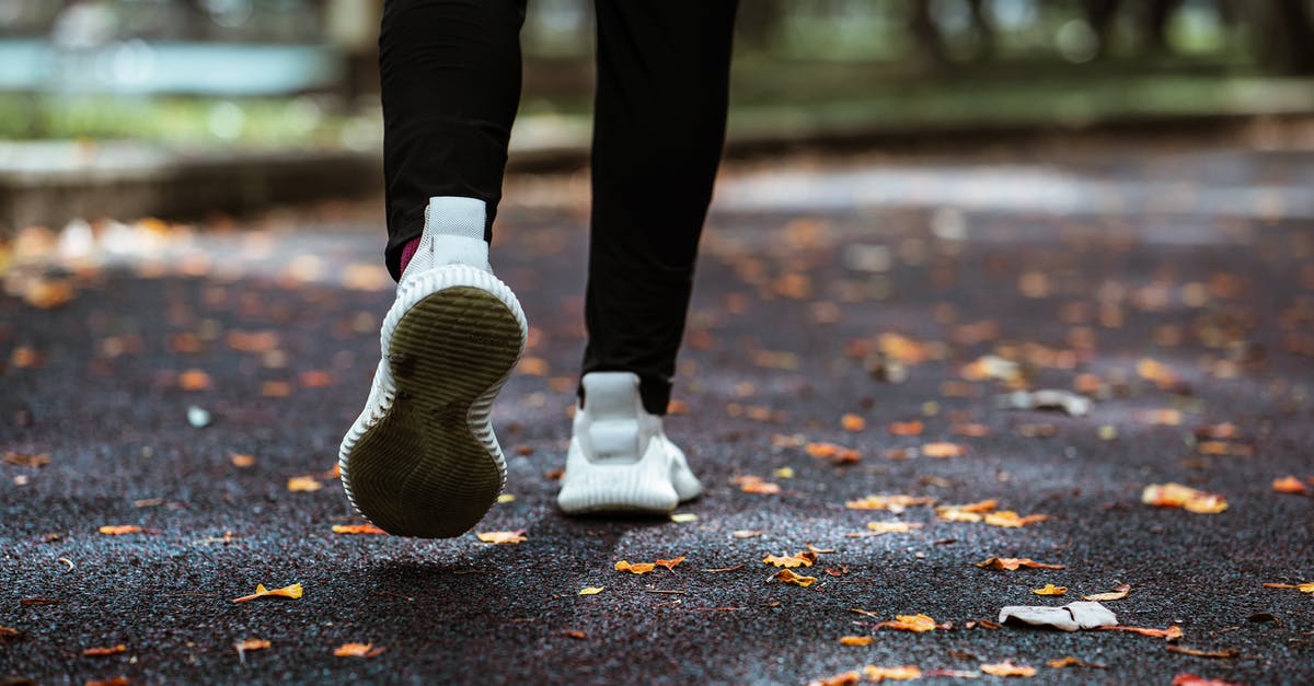 How many steps is one run around Prism Tower? - Legs of anonymous person in white sneakers and black leggings running on sidewalk How many steps is one run around Prism Tower? - Legs of anonymous person in white sneakers and black leggings running on sidewalk