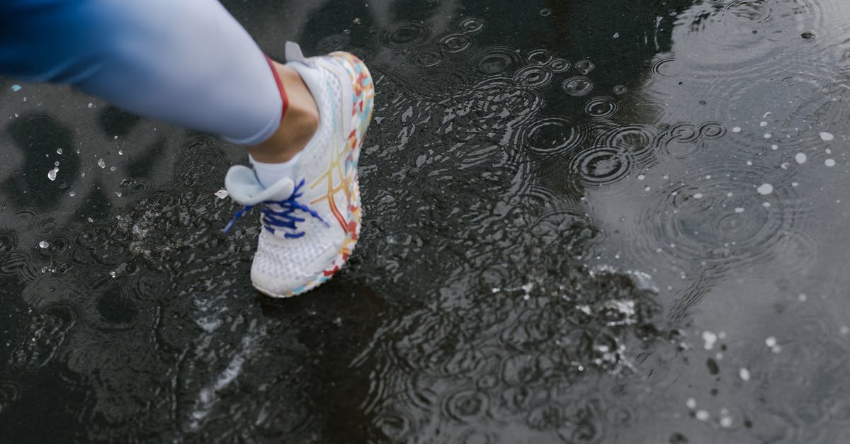 How many steps is one run around Prism Tower? - A Person Wearing a White Shoes while Stepping on Wet Road How many steps is one run around Prism Tower? - A Person Wearing a White Shoes while Stepping on Wet Road