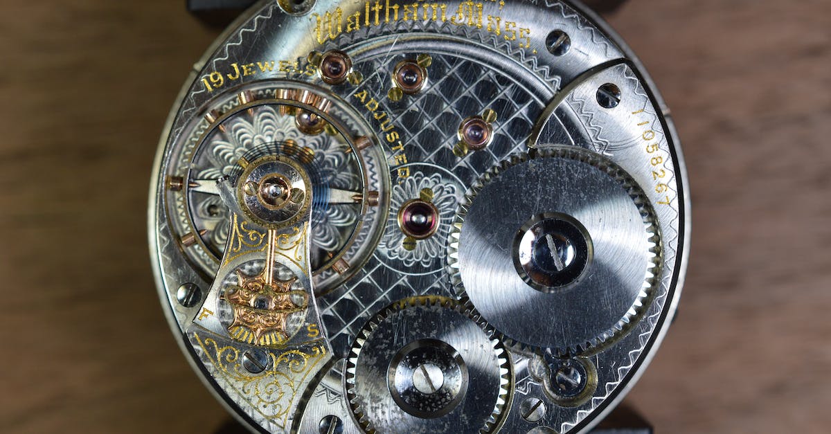 How many times should I rotate the gear wheels? - Round Gray Skeleton Watch on Brown Pad