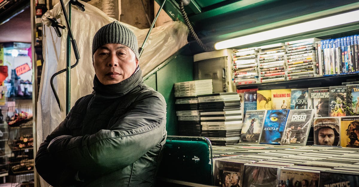 How many vendors should I assign to my markets? - Asian man selling DVD discs