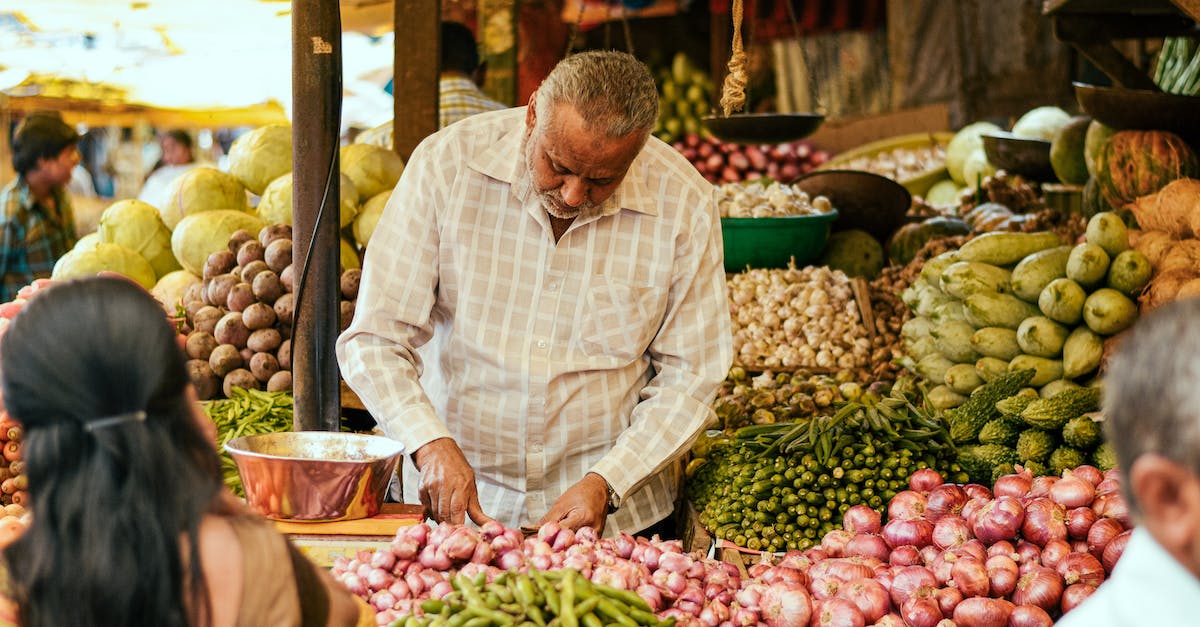 How many vendors should I assign to my markets? - Ethnic seller working at local bazaar with vegetables