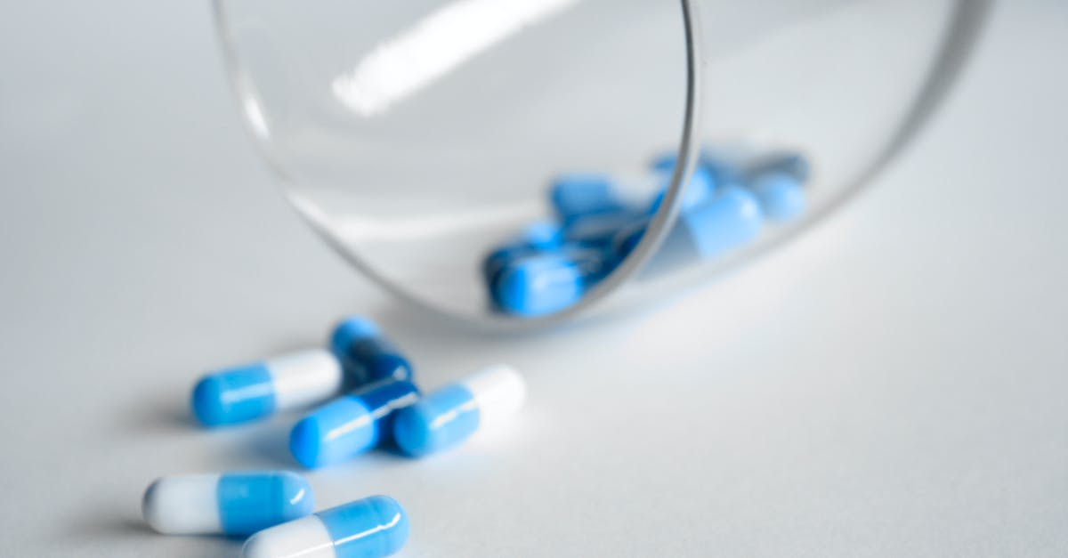 How much ammo will a Medic see on their HUD while healing a spy? - Depth Photography of Blue and White Medication Pill