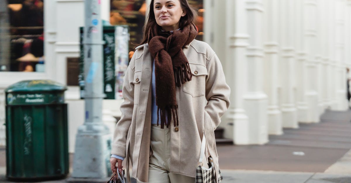 How much carry weight does "Pocketed" add? - Positive female walking with hand in pocket on sidewalk and carrying bags during shopping in city