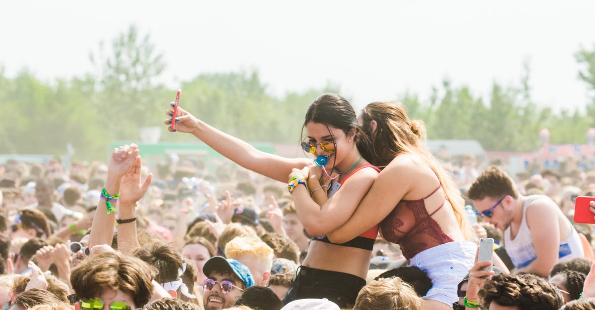 How much does friendship raise exactly with TM method? - Two Women Embracing Surrounded by Crowd