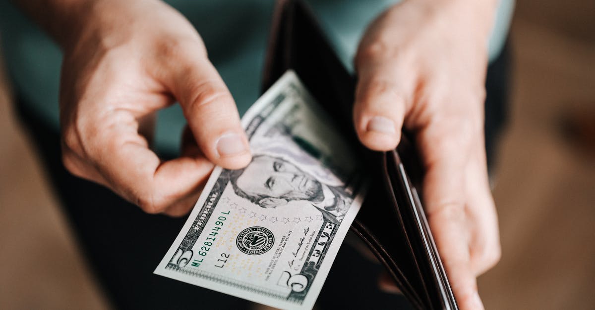 How much influence does it take to level up? - Unrecognizable man holding wallet with money