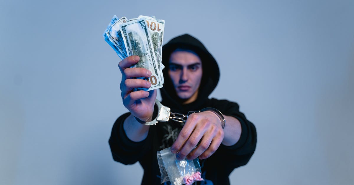 How much money does the radio man require for compensation? - A Man in Black Hoodie Sweater Wearing Handcuffs while Holding Money and Drugs How much money does the radio man require for compensation? - A Man in Black Hoodie Sweater Wearing Handcuffs while Holding Money and Drugs
