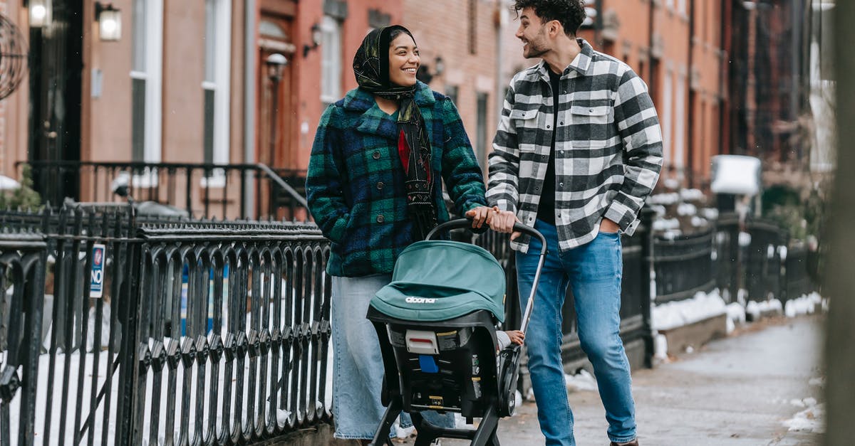 How much tax does each zoned building generate? - Happy multiethnic parents walking with baby stroller