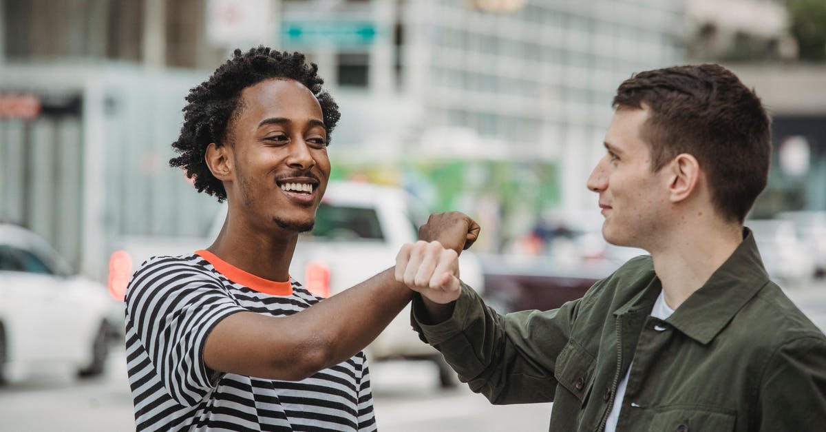 How much tax does each zoned building generate? - Cheerful young diverse male friends in casual clothes bumping arms and smiling while greeting each other on modern city street How much tax does each zoned building generate? - Cheerful young diverse male friends in casual clothes bumping arms and smiling while greeting each other on modern city street