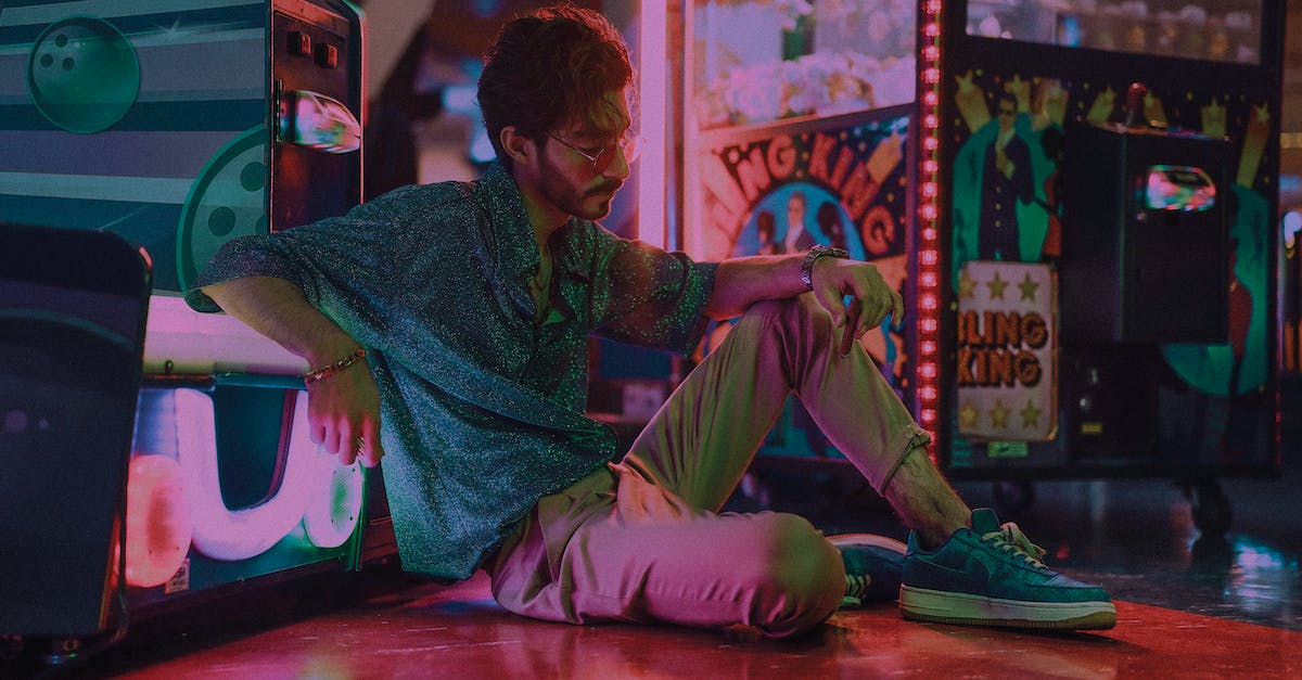 How often do "Something Happened" slot machines appear? - Full body of male with beard wearing sunglasses sitting near slot machines with bent leg in shopping mall at low light How often do "Something Happened" slot machines appear? - Full body of male with beard wearing sunglasses sitting near slot machines with bent leg in shopping mall at low light