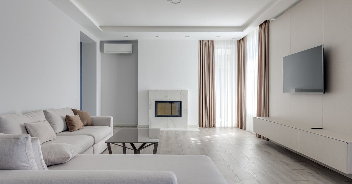 How often should I visit to see whether Tubbs will lounge on the giant cushion? - Interior of light living room in pastel colors with comfortable couch near glass table and TV set