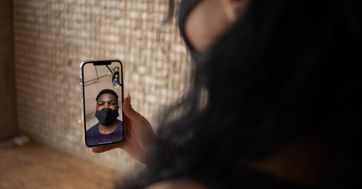 How prevent orbit change while using RCS to point probe anti-radial all time - Back view of crop anonymous female talking to ethnic male beloved in fabric mask during video call on cellphone