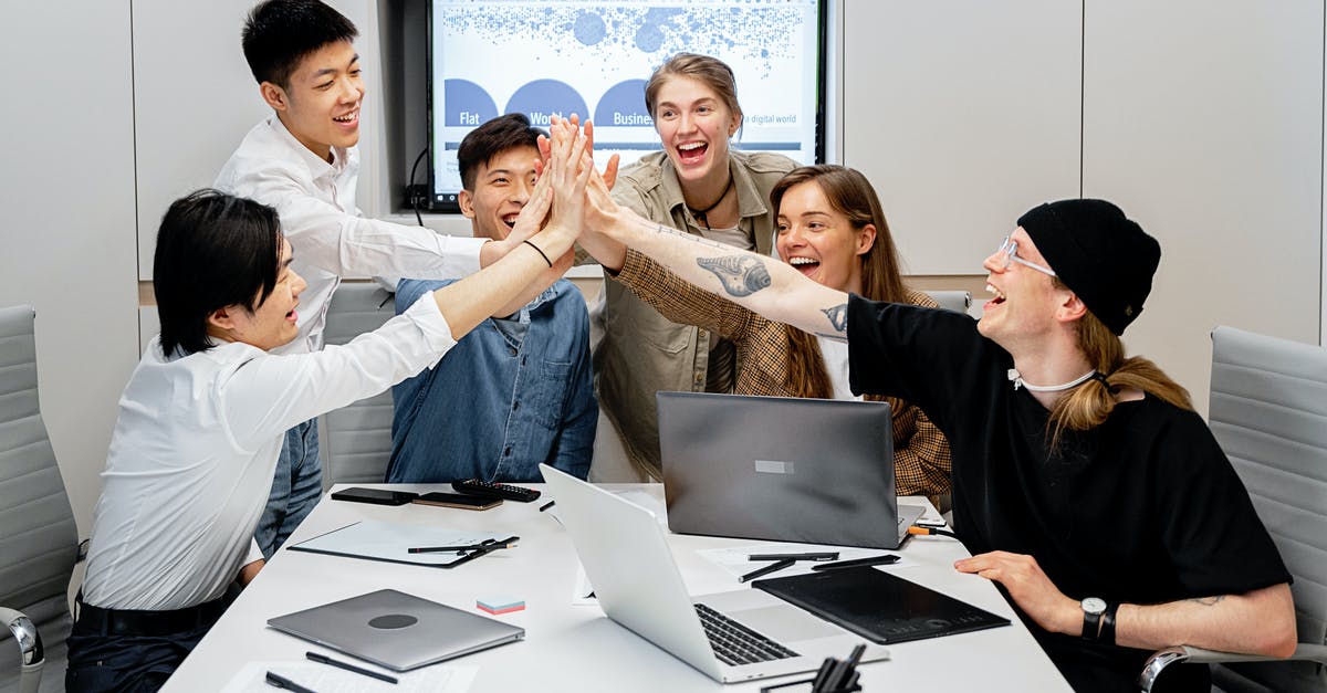 How should I switch a person to another team in minecraft? - Man and Woman Sitting at Table With Macbook