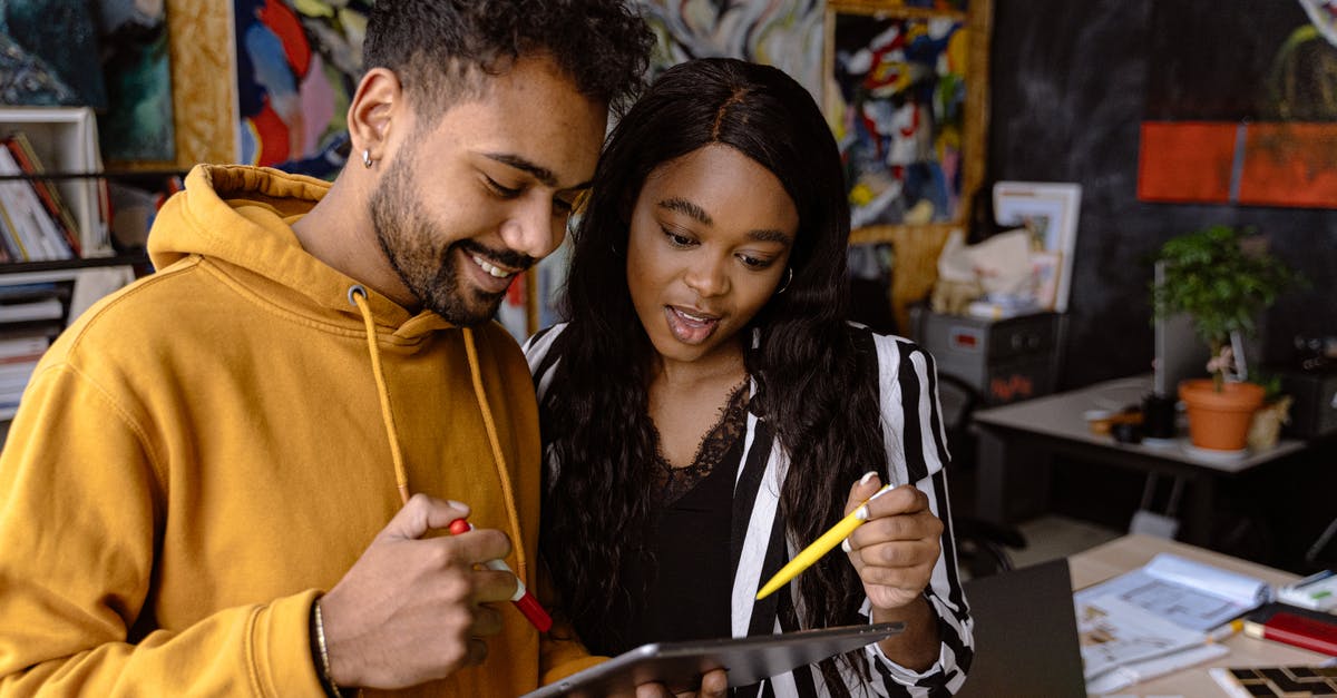 How should I switch a person to another team in minecraft? - Man in Orange Hoodie Holding Black Pen