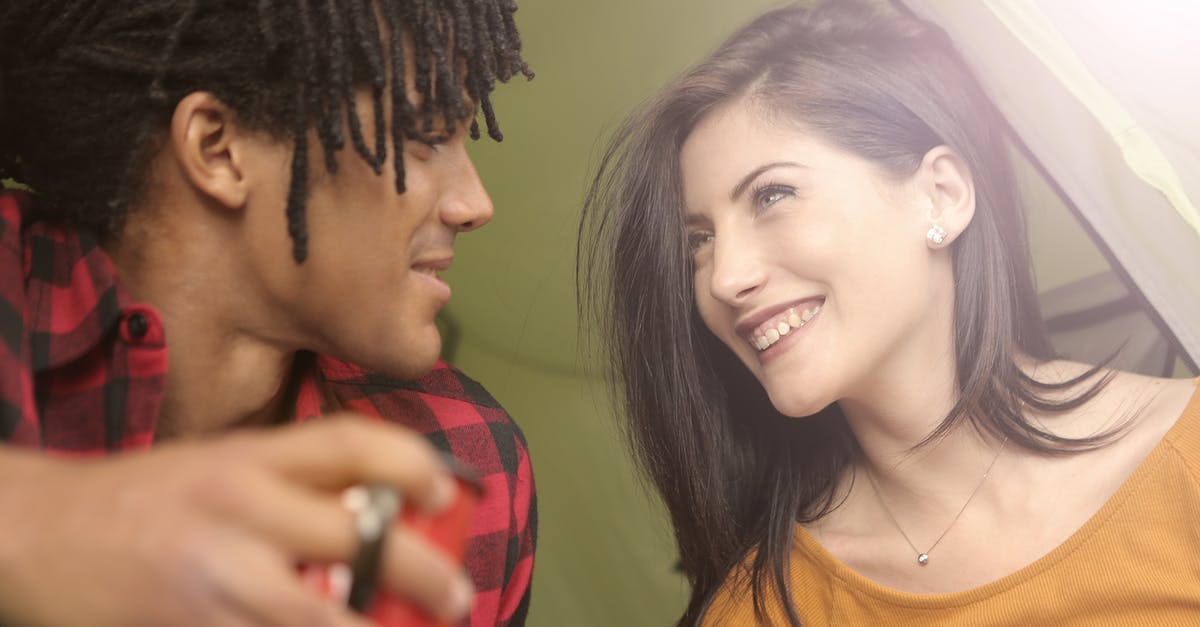 How should I travel to the other regions of Mira? - Cheerful multiracial couple looking at each other