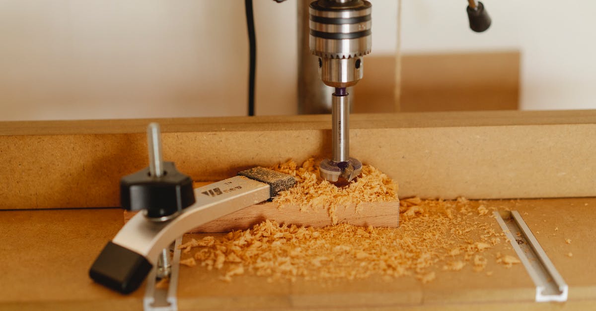 How to activate a lever with another lever? - Electric drill press making hole in timber plank fixed with carpenter vice on workshop table How to activate a lever with another lever? - Electric drill press making hole in timber plank fixed with carpenter vice on workshop table