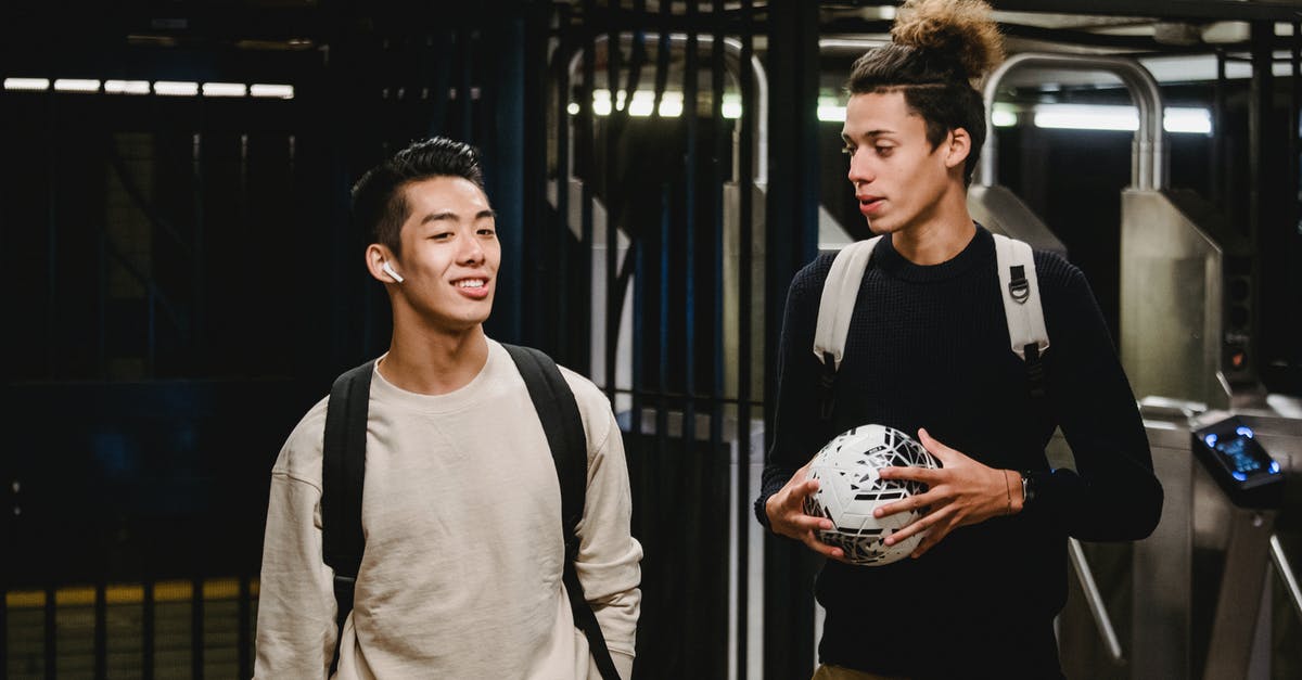 How to activate Nyakuza Metro Preorder Bonus? - Cheerful ethnic male friends in casual sweaters with backpacks and soccer ball walking in modern metro station and having conversation How to activate Nyakuza Metro Preorder Bonus? - Cheerful ethnic male friends in casual sweaters with backpacks and soccer ball walking in modern metro station and having conversation