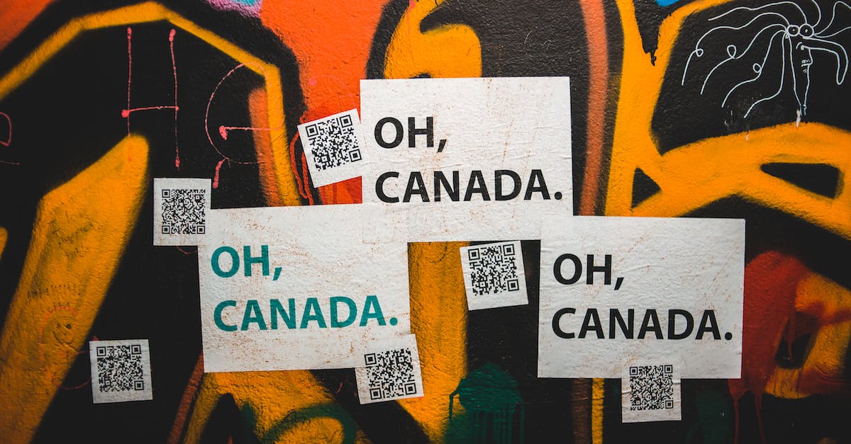 How to activate the QR code puzzles? - Colorful graffiti wall with Oh Canada inscription and QR codes on city street
