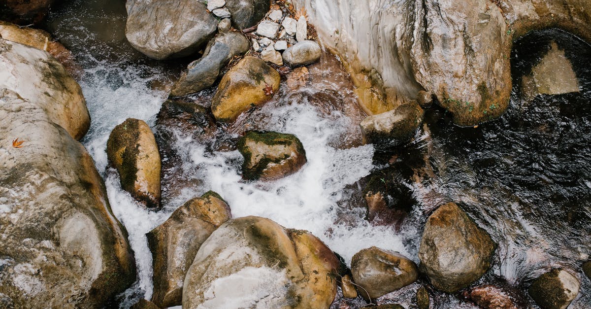 How to allow gasses to flow through my base? - From above of fresh fast curvy stream of mountain water flowing through big slick stones