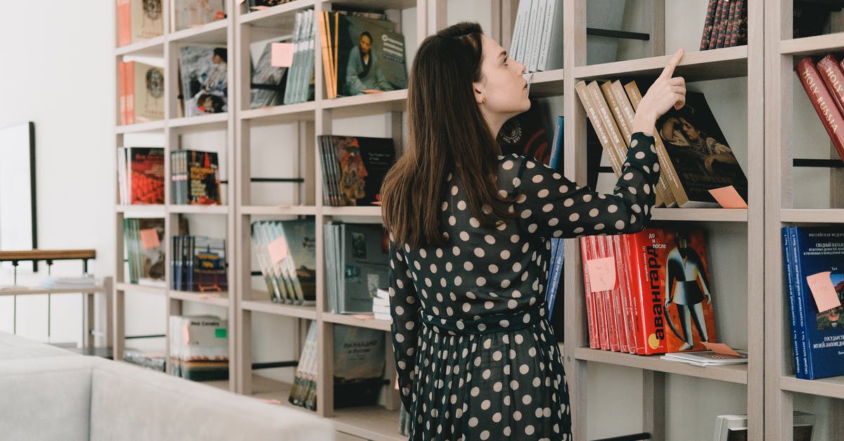 How to assign many blockers at the same time? - Young woman choosing book from bookshelf How to assign many blockers at the same time? - Young woman choosing book from bookshelf